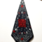 Black printed bandana with white paisley, skulls, and red rose design