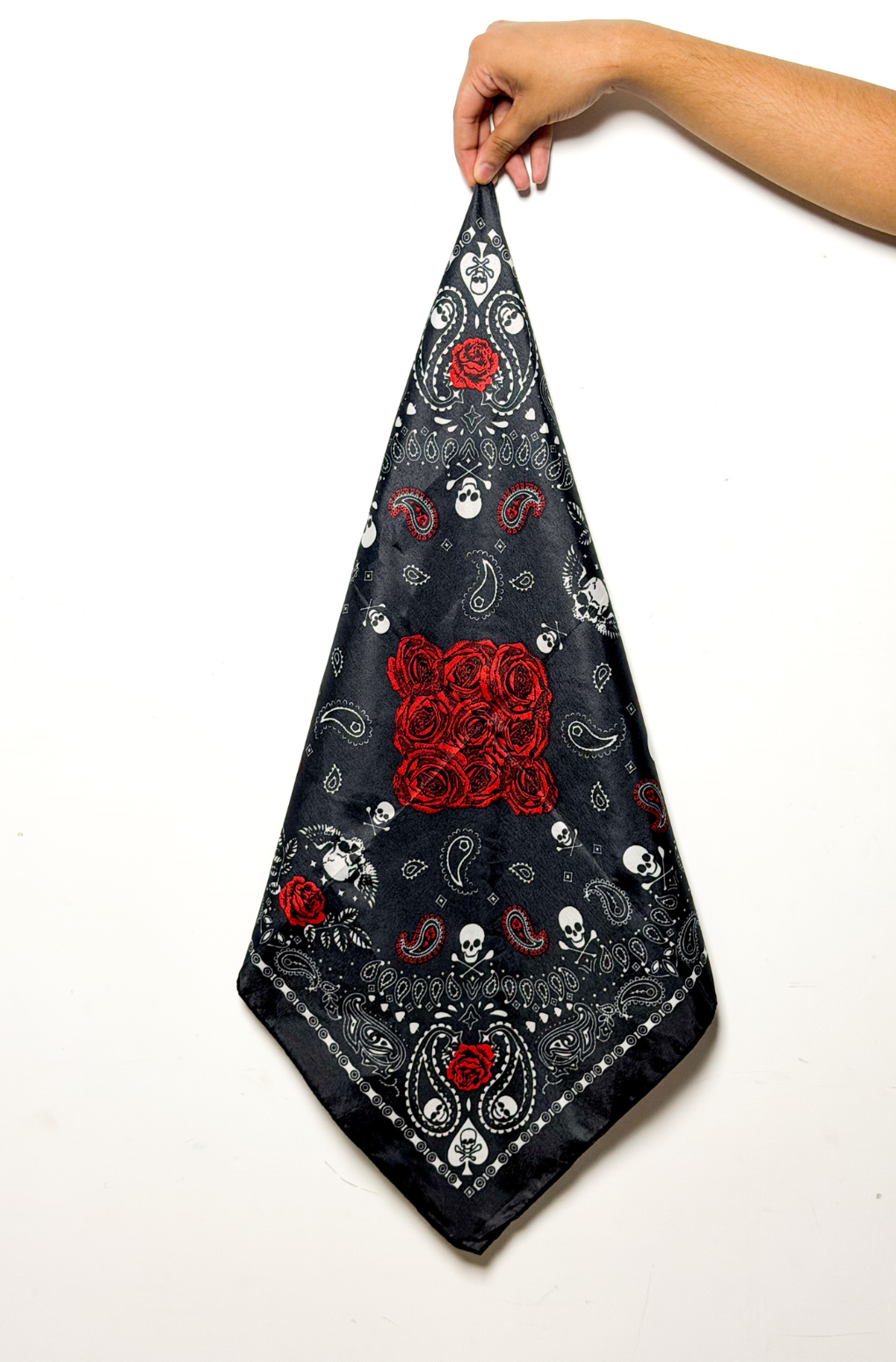 Black printed bandana with white paisley, skulls, and red rose design