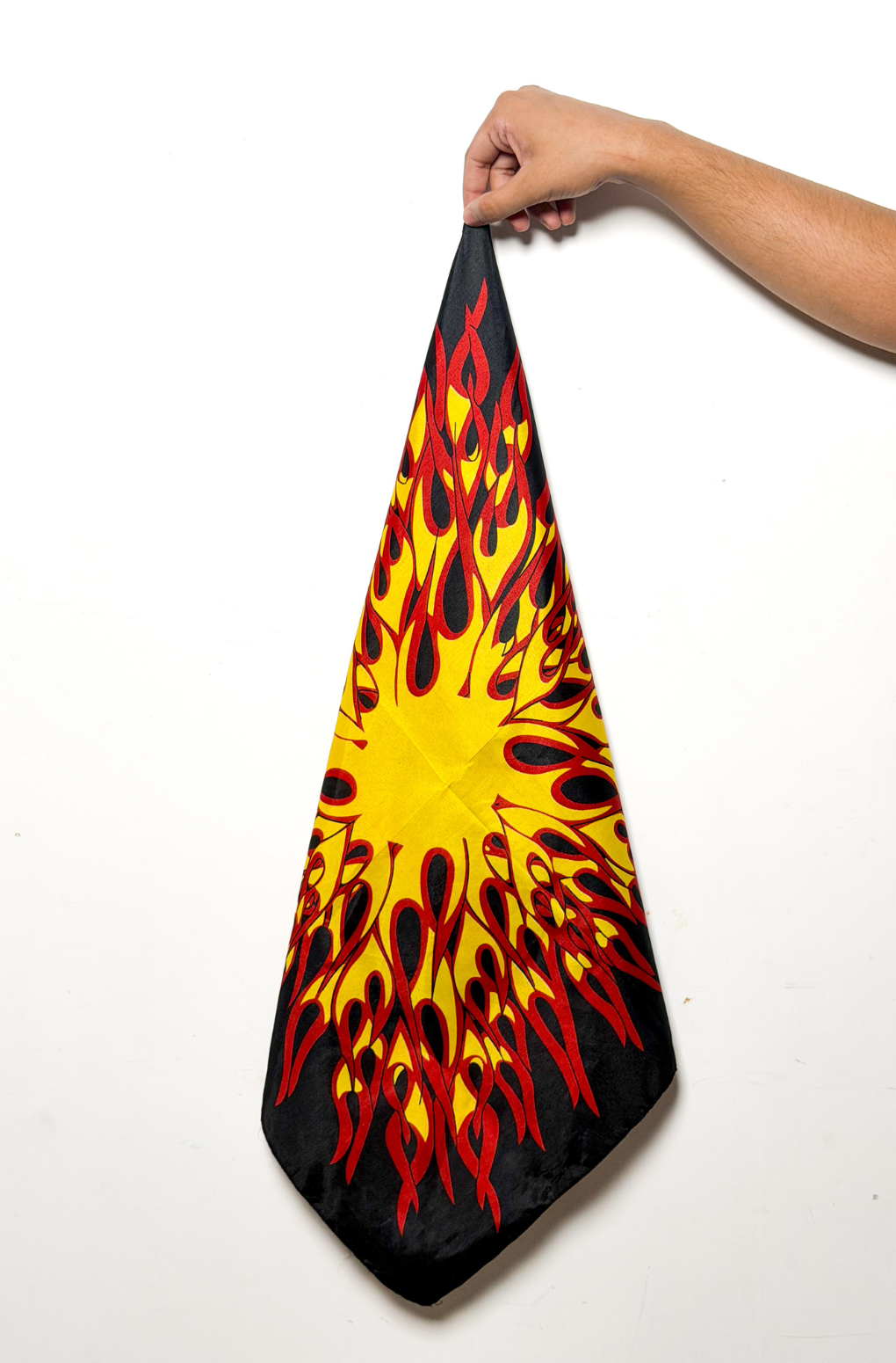 Black bandana with printed yellow and red flame sunburst design
