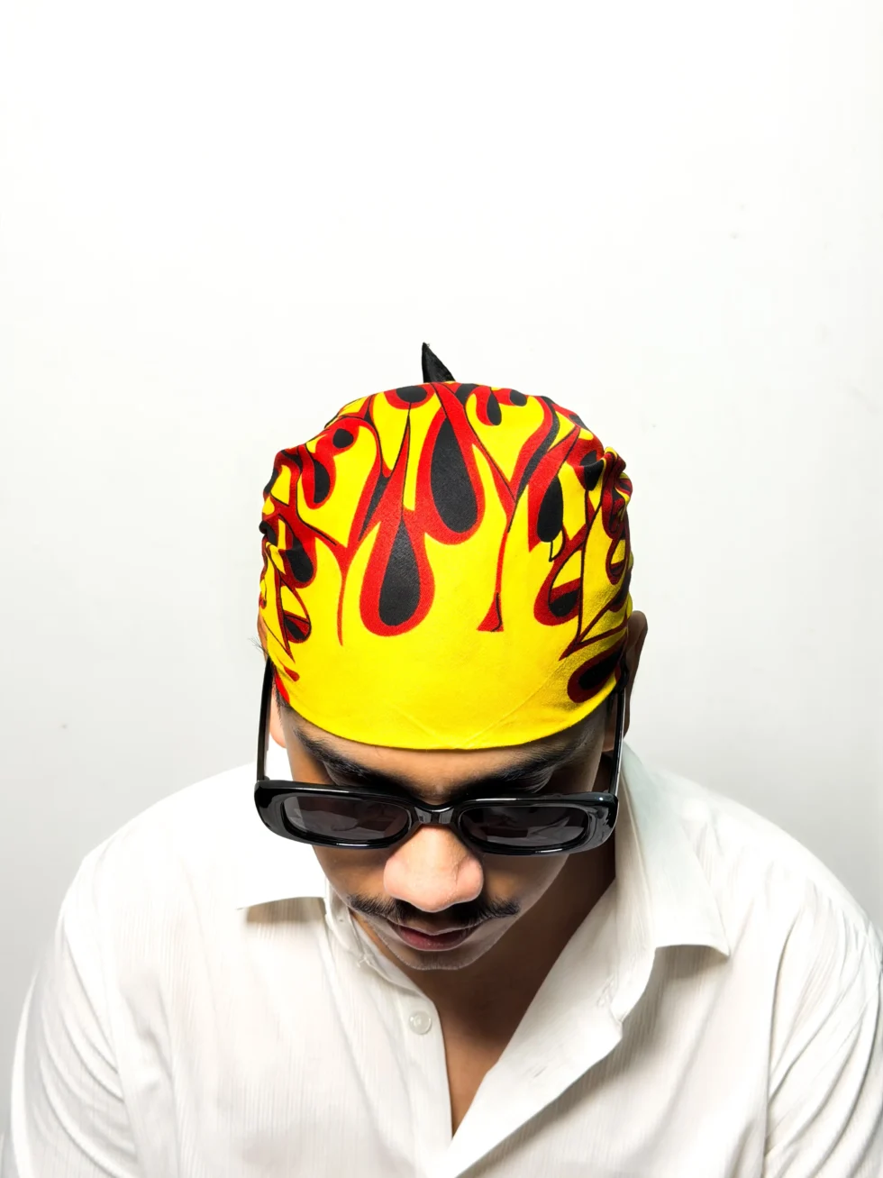 Black bandana with printed yellow and red flame sunburst design