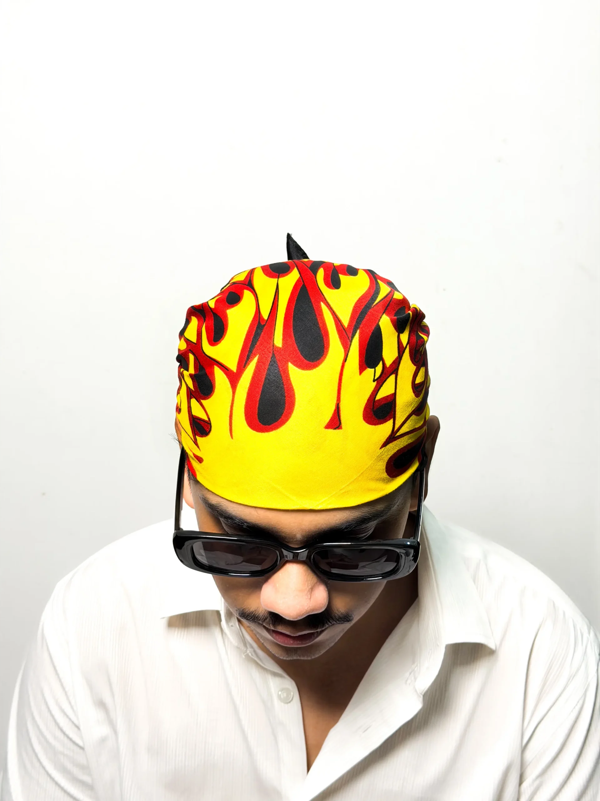 Black bandana with printed yellow and red flame sunburst design